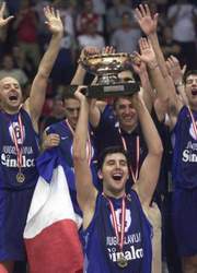 Yugoslavia's captain Dejan Bodiroga holds up the trophy